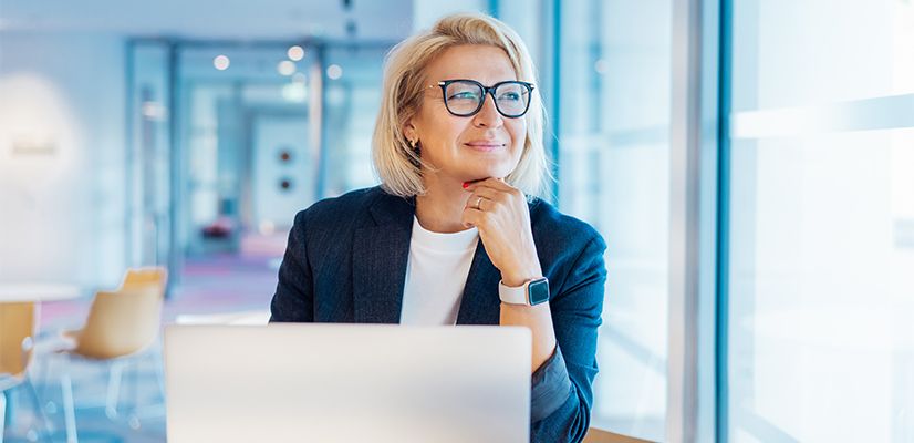 Businesswoman on computer looking out window