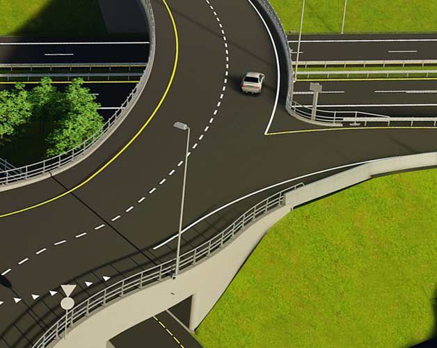 A car drives on a multi-level highway interchange with green grass surrounding the roads.