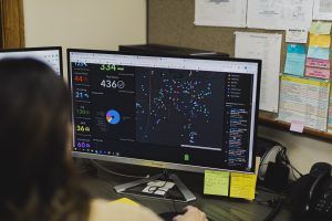 A person is looking at a computer screen displaying a dashboard with data visualizations and charts.