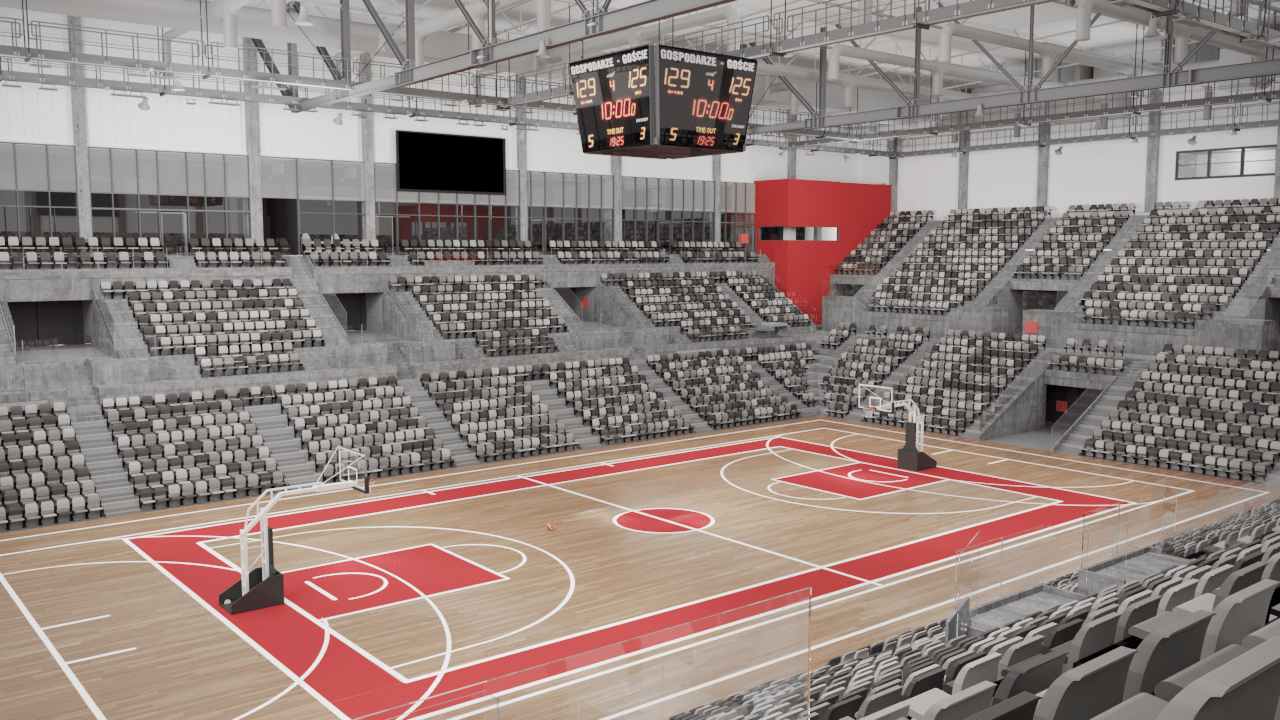 Empty basketball arena with red and white court markings and seating.