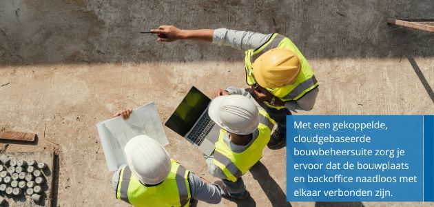 Three construction workers in hard hats and safety vests collaborate on a construction site, reviewing blueprints and a laptop.
