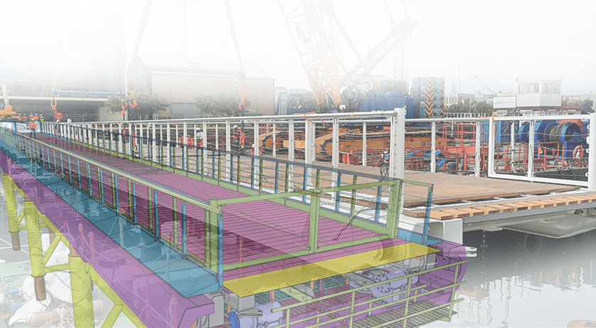 A 3D rendering of a miniature bridge is overlaid on a photograph of a shipyard.