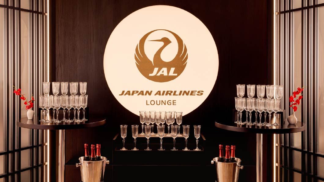 The Japan Airlines (JAL) Lounge branding and logo illuminated on a dark feature wall inside Anfield stadium.