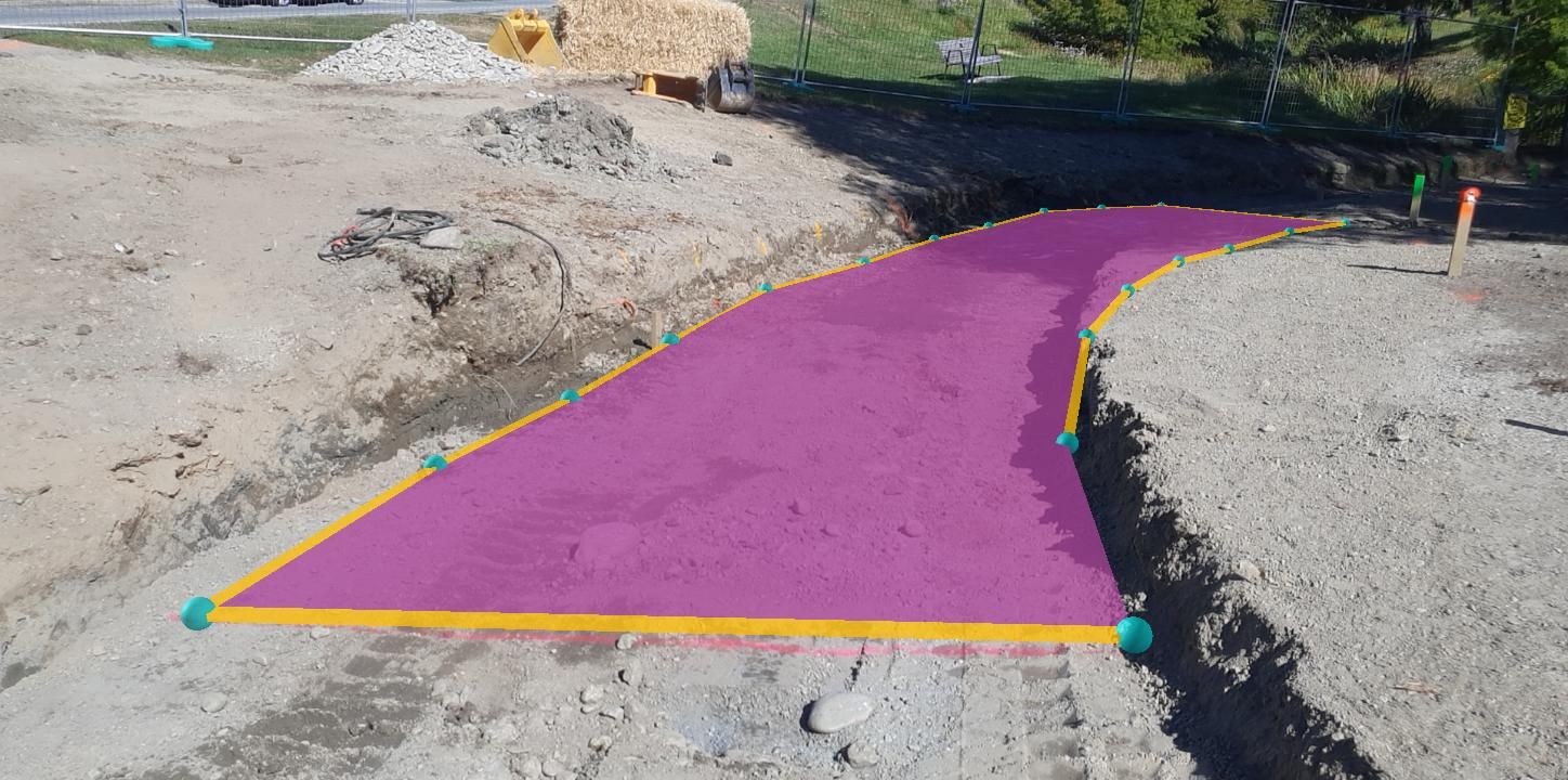 Construction site with a purple-highlighted path outlined in yellow and marked by green and yellow posts.