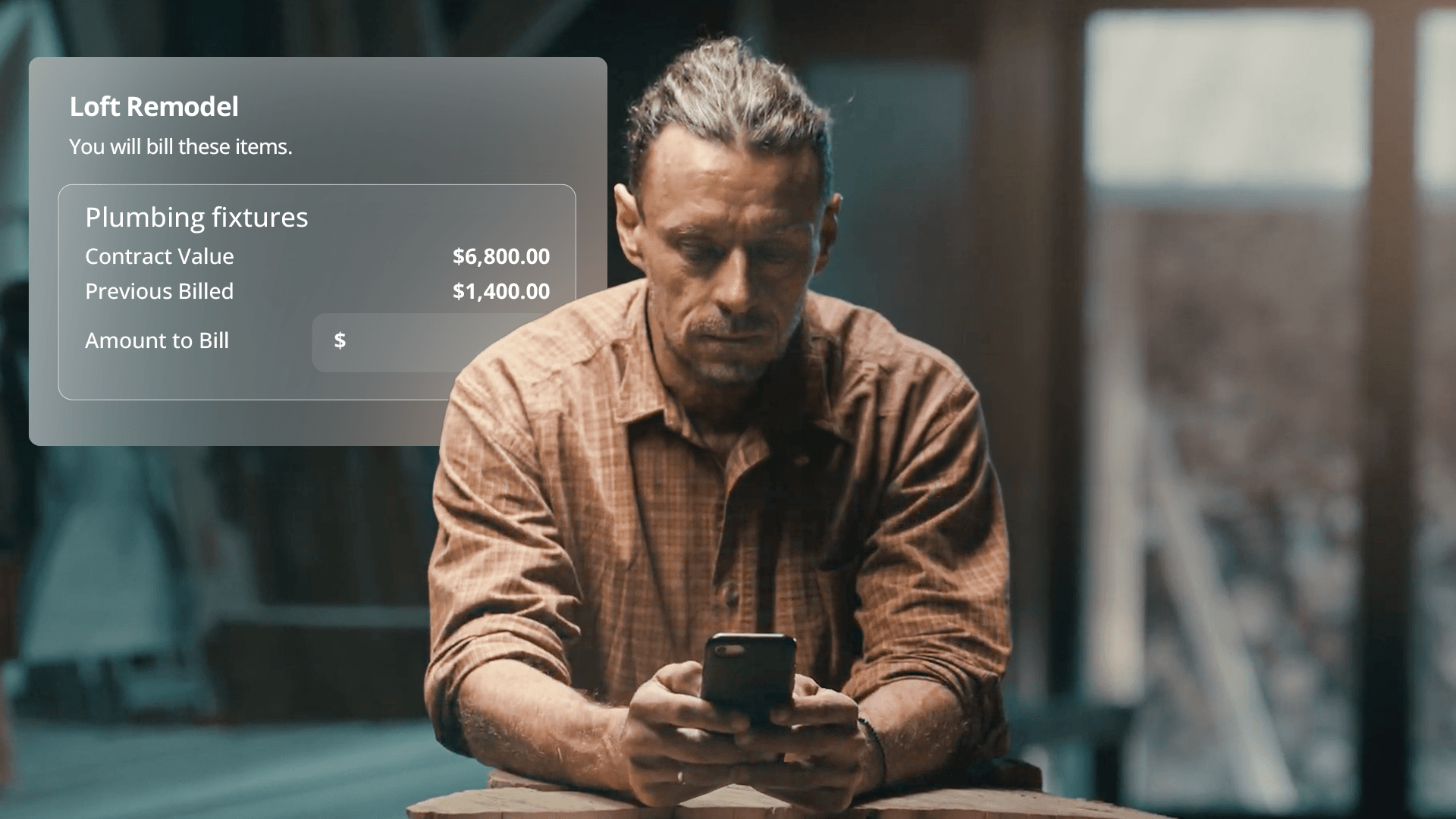 A contractor looks closely at his smartphone with a "Loft Remodel" digital billing menu overhead.