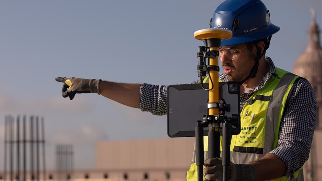 A surveyor from JE Dunn out on a construction site