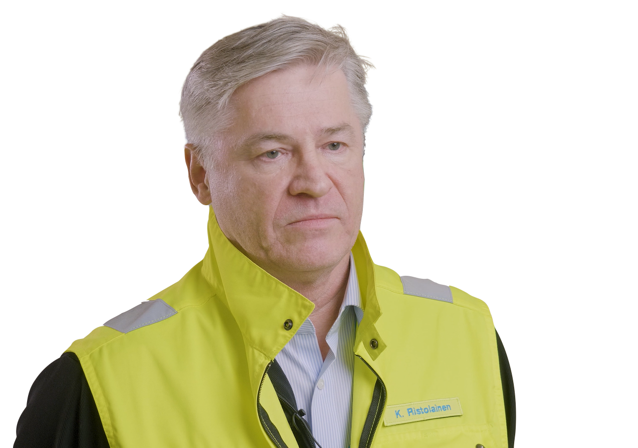 A man with grey hair wears a bright yellow vest over a light blue collared shirt.