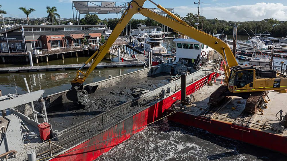 Excavator dredging the mud-like material