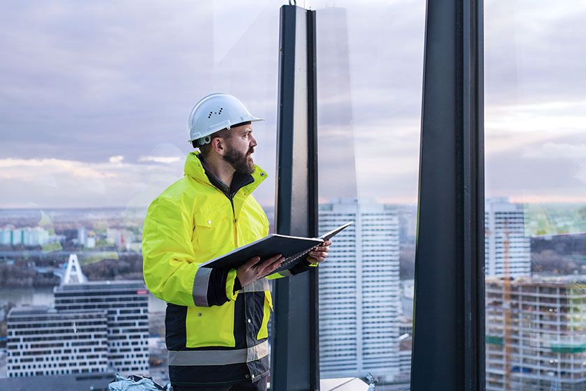 Builder checking plans at a highrise building
