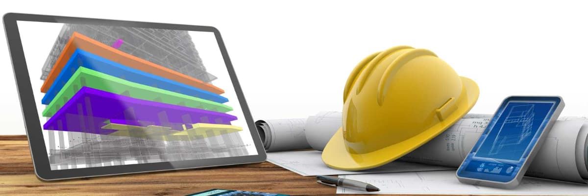 A tablet displaying a 3D architectural model, and a yellow hard hat, a smartphone showing a blueprint, and rolled blueprints on a wooden desk.