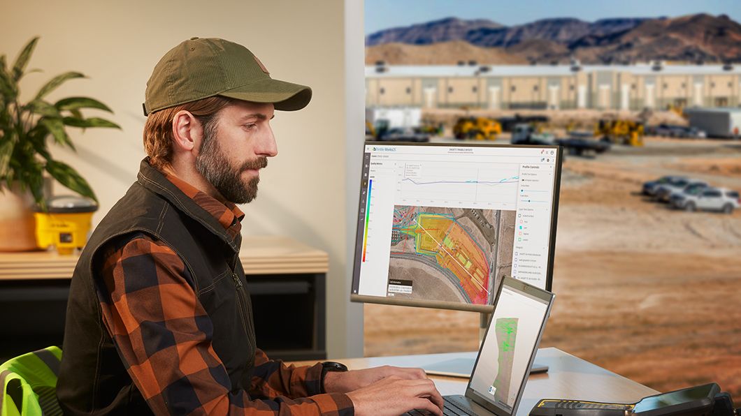A site manager in the office processes site data on Trimble WorksManager and Trimble Business Center