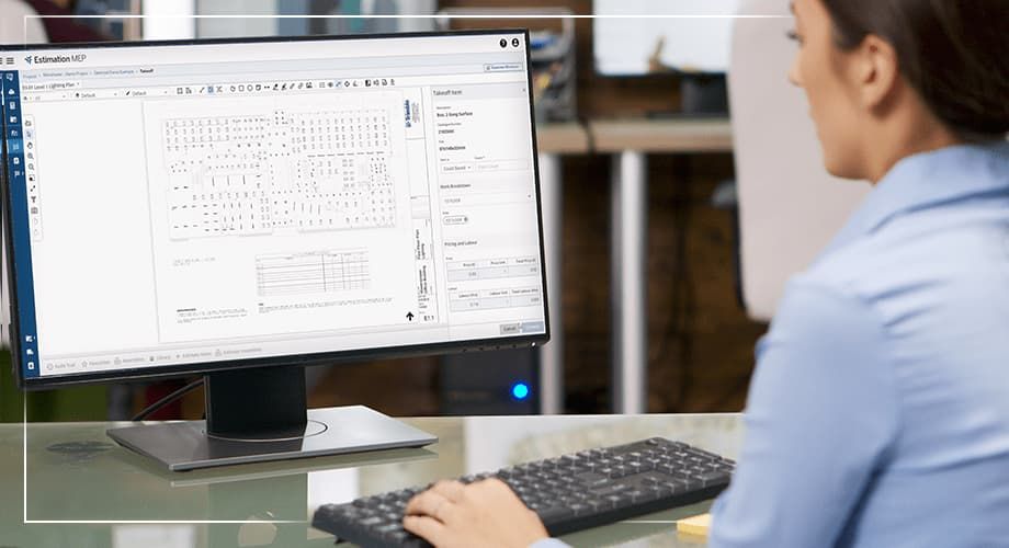 Woman using specialized software on a computer to analyze and estimate project data.