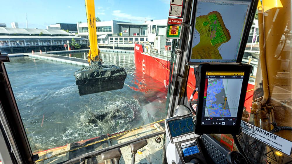 Operator in cab dredging with TMC system