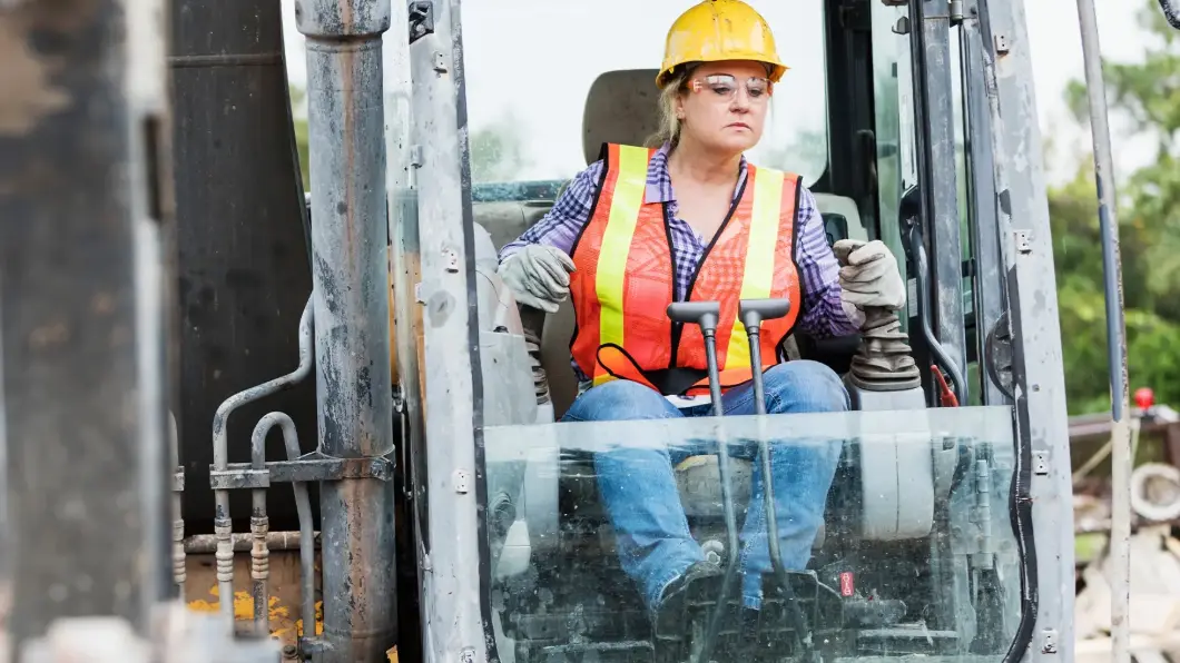 Construction worker running large equipment