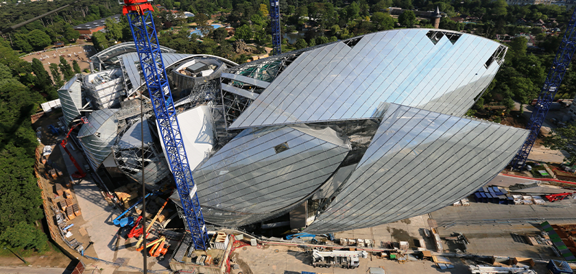 View of Fondation Louis Vuitton under construction from above, shows main glass sail being fitted