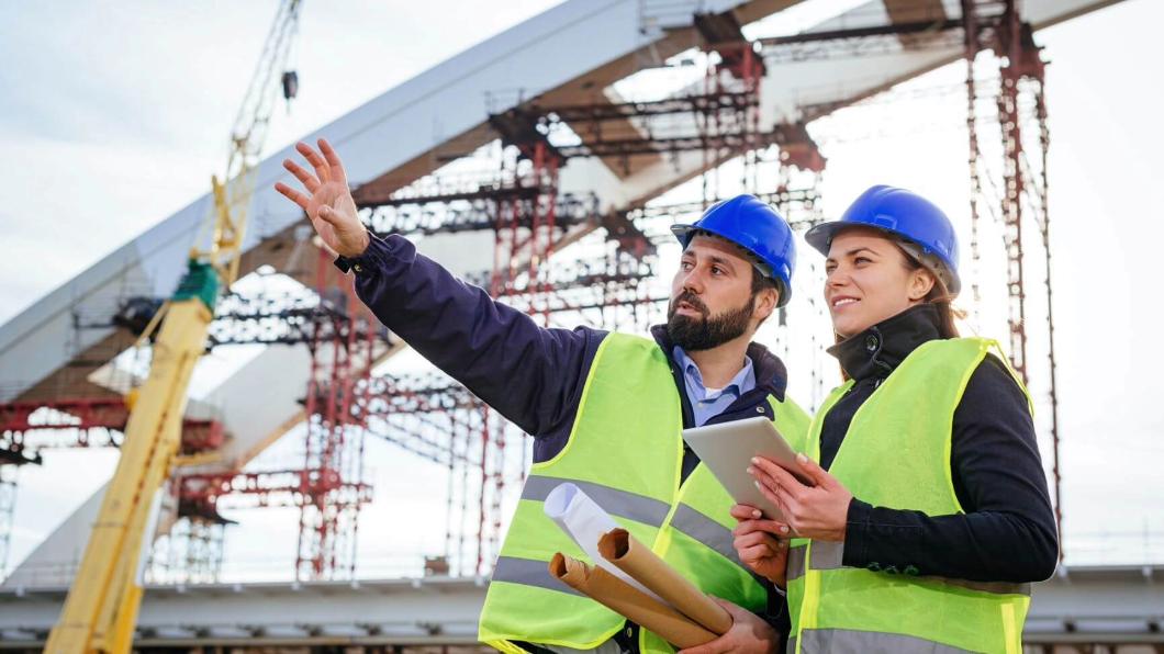 Construction workers using data analytic tools in the field