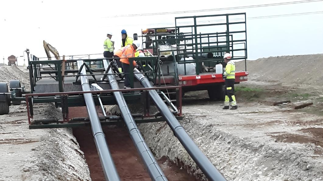Workers laying an underground cable system